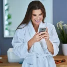 beautiful-brunette-woman-with-smart-phone-bathroom_470178-4378